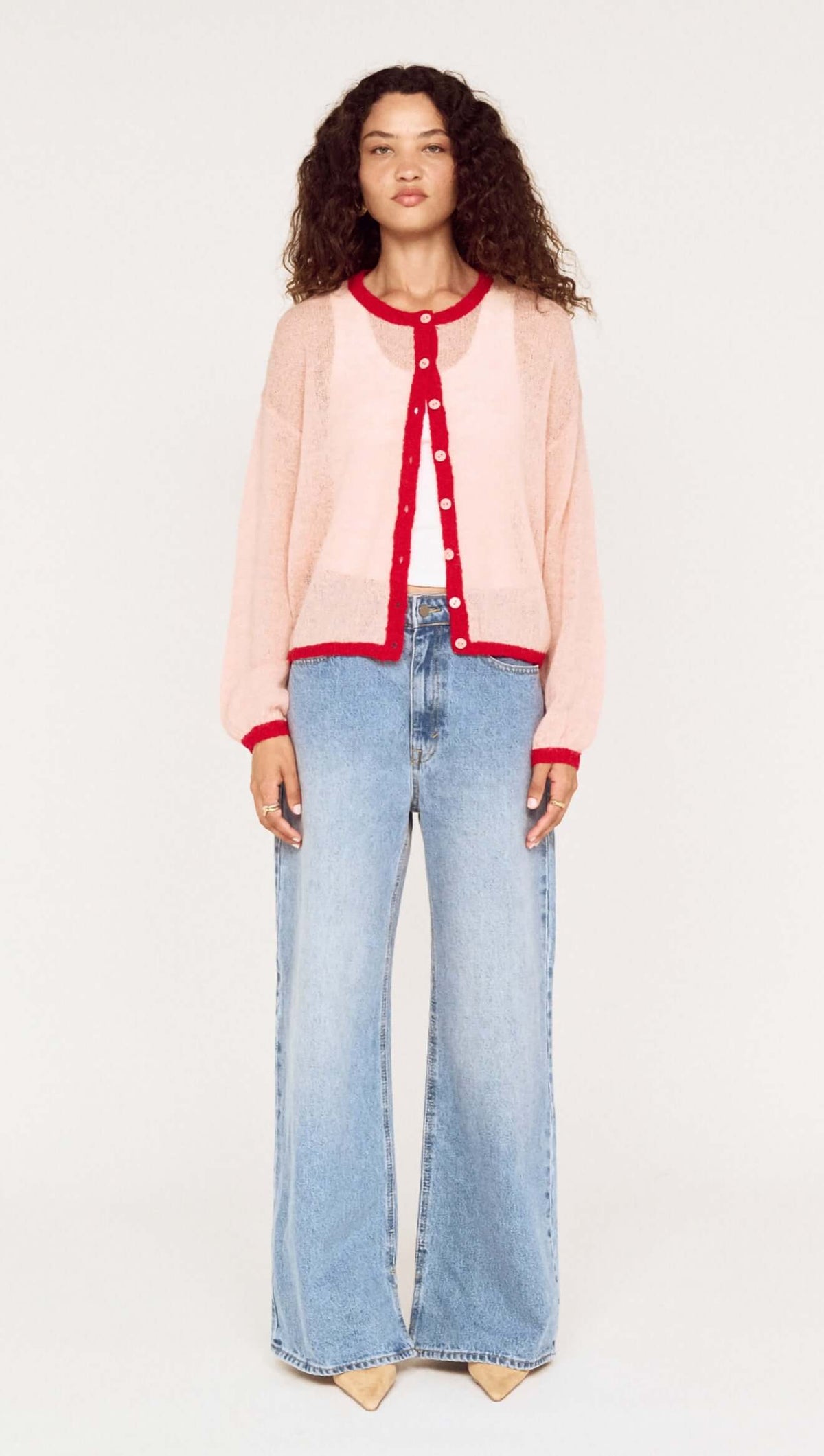 Sheer Contrast Trim Pink Cardigan worn with wide-leg jeans, showcasing a stylish, playful knitwear look.