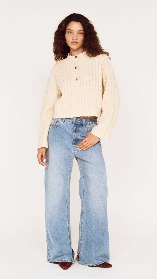 Fine Cable Knit Top with Gold Detail worn with relaxed denim, showcasing a stylish cropped silhouette and button details.