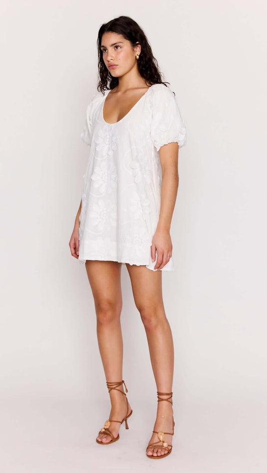 White Cotton Floral Applique Smock Mini Dress featured on a model, showcasing relaxed fit and puff sleeves.