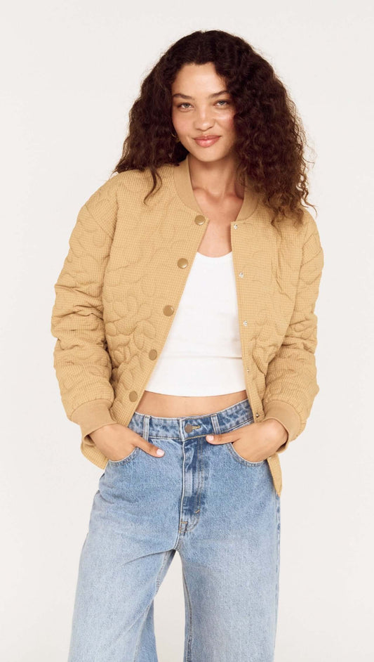 Beige Floral Quilted Puffer Jacket worn by a model, featuring a relaxed fit and soft quilted texture.
