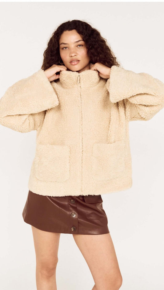 Woman wearing a Beige Teddy Jacket with High Collar over a brown skirt, showcasing a stylish winter outfit.