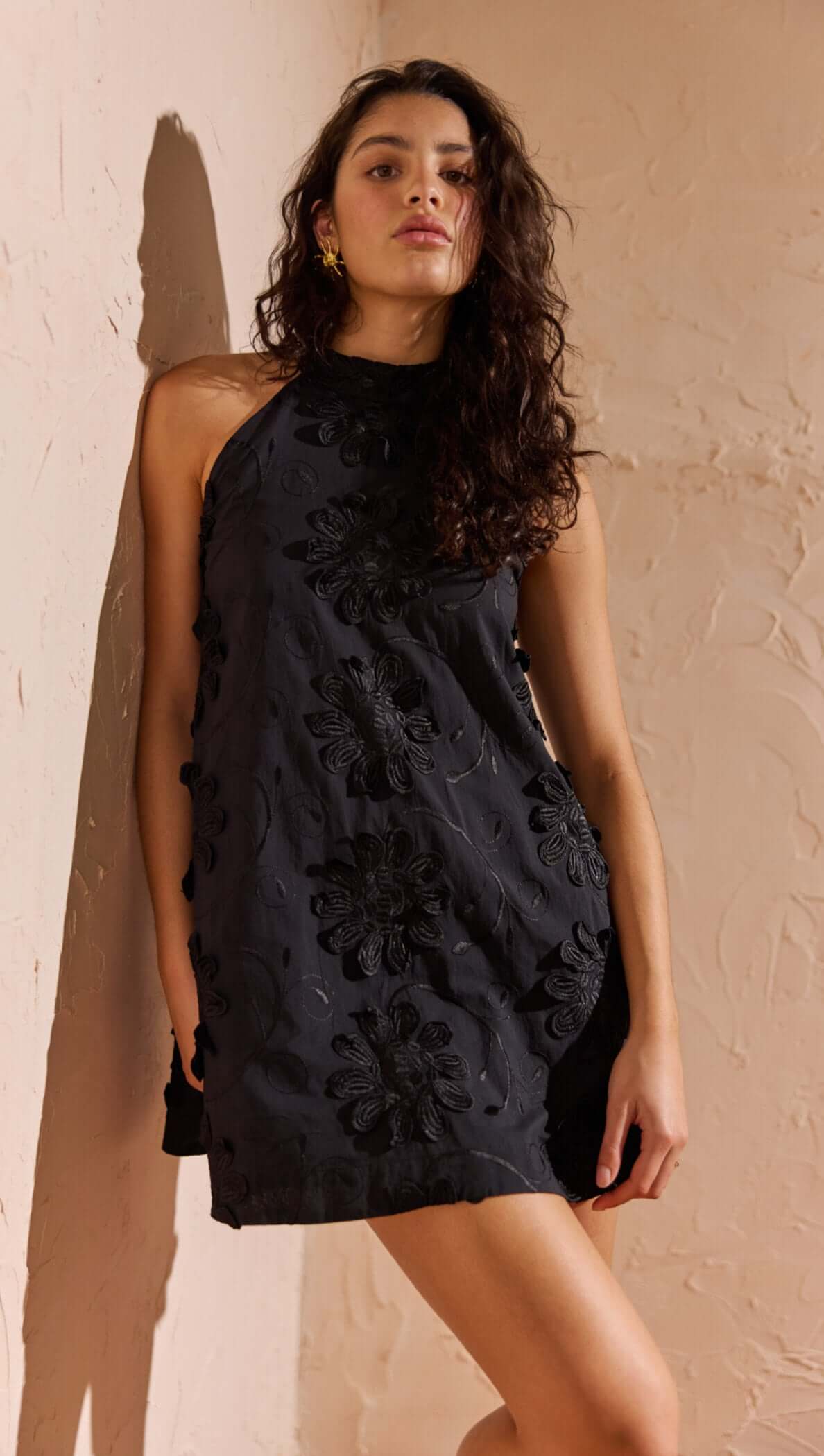 Black Cotton Applique High Neck Mini Dress in black with floral applique detail on a model.