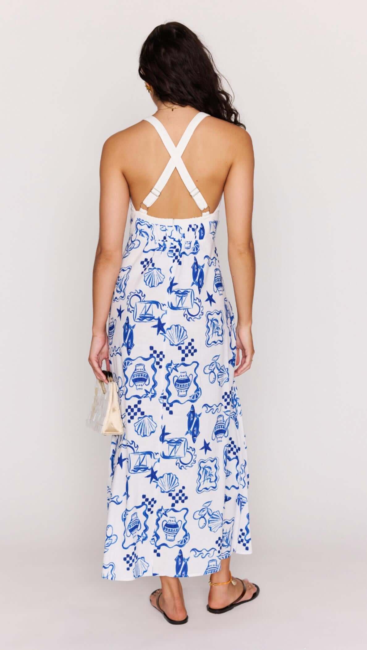 Blue Summer Cotton Blend Halter Neck Midi Dress showing a cross-back design and vibrant blue-and-white print from the back.