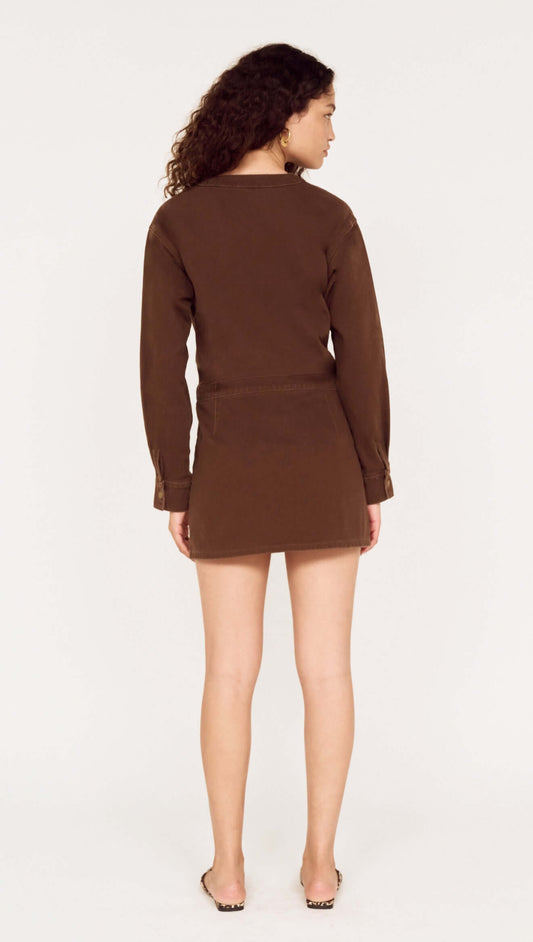 Back view of a model wearing a Brown Denim Wrap Mini Dress, showcasing the style and fit.