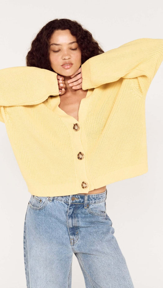 Butter Yellow Oversized Cardigan with Volume Sleeve worn by model, featuring button details and relaxed fit.