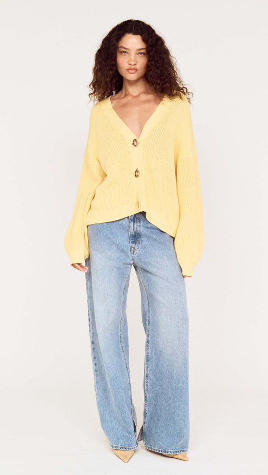Model wearing a Butter Yellow Oversized Cardigan with Volume Sleeve paired with wide-leg jeans.