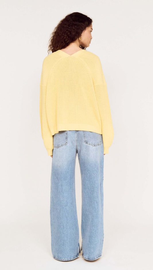 Butter Yellow Oversized Cardigan with Volume Sleeve worn with wide-leg jeans from the back view.