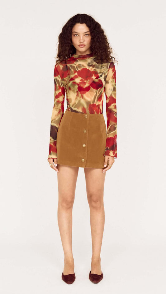 Model wearing a floral top and Button Front Faux Sude Mini Skirt showcasing a trendy fashion look.