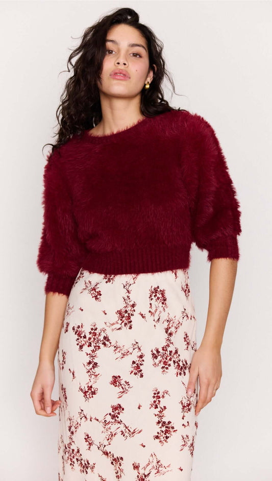 Model showcases the Cream Floral Toile Bias Cut Maxi Skirt paired with a cozy burgundy cropped sweater.