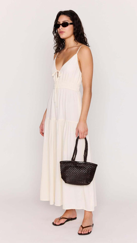 Cream Tie Front Tiered Maxi Dress displayed on a model, featuring a tie-front neckline and flowing skirt.