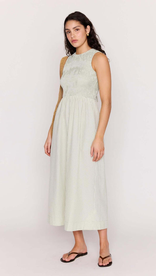 Model wearing a Green Gingham Smocked Midi Dress in seersucker fabric, perfect for warm-weather occasions.