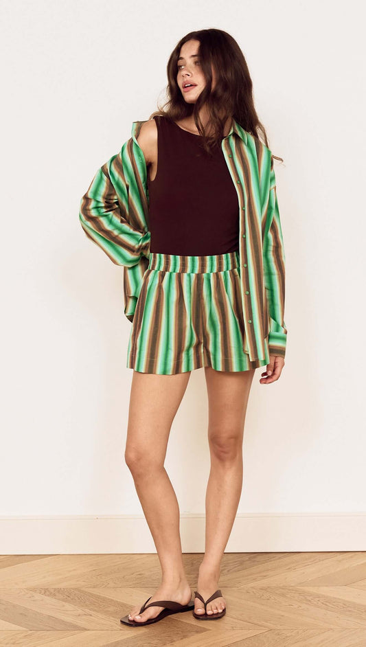 Model wearing Green Stripe Cotton Relaxed Short with a matching shirt and sandals, showcasing relaxed summer style.