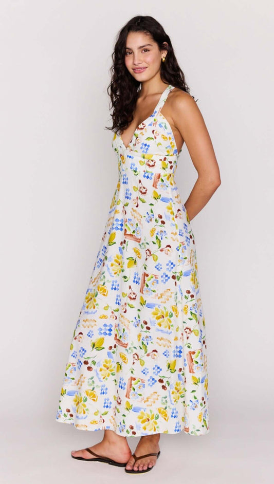 A model wearing the Mediterranean Print Halter Midi Dress, showcasing its flattering V-neckline and vibrant floral print.