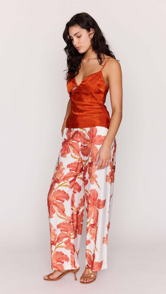 A model showcases the Orange Bead Detail Satin Cami paired with vibrant floral pants for a stylish look.