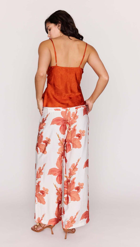 Model showcasing Orange Bead Detail Satin Cami paired with floral wide-leg pants from the back view.