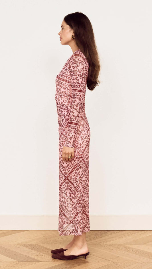 Model showing the side view of the Pink Paisley Long Sleeve Mesh Midi Dress on a wooden floor.