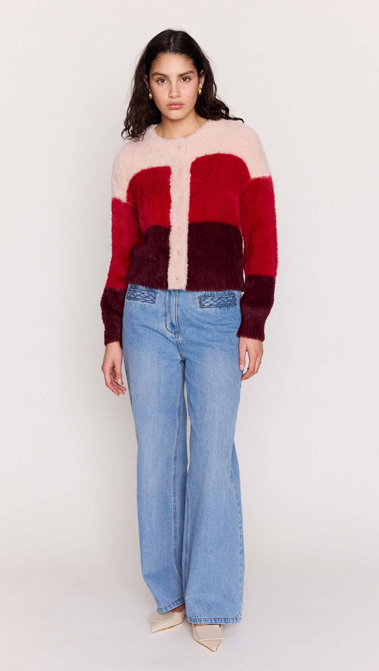 A model wearing a Red Colour Block Fluffy Cardigan with soft texture, paired with light blue jeans.