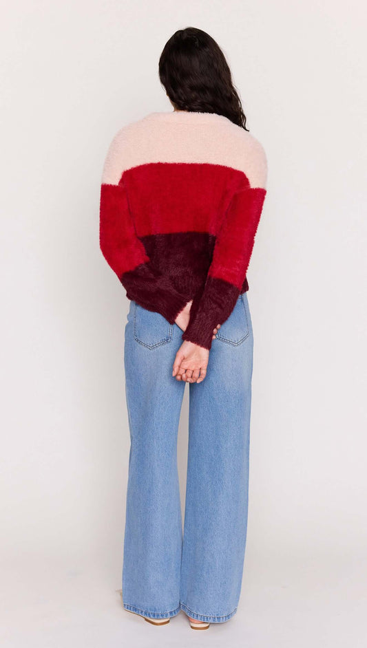 Back view of a model wearing the Red Colour Block Fluffy Cardigan with wide-leg jeans.