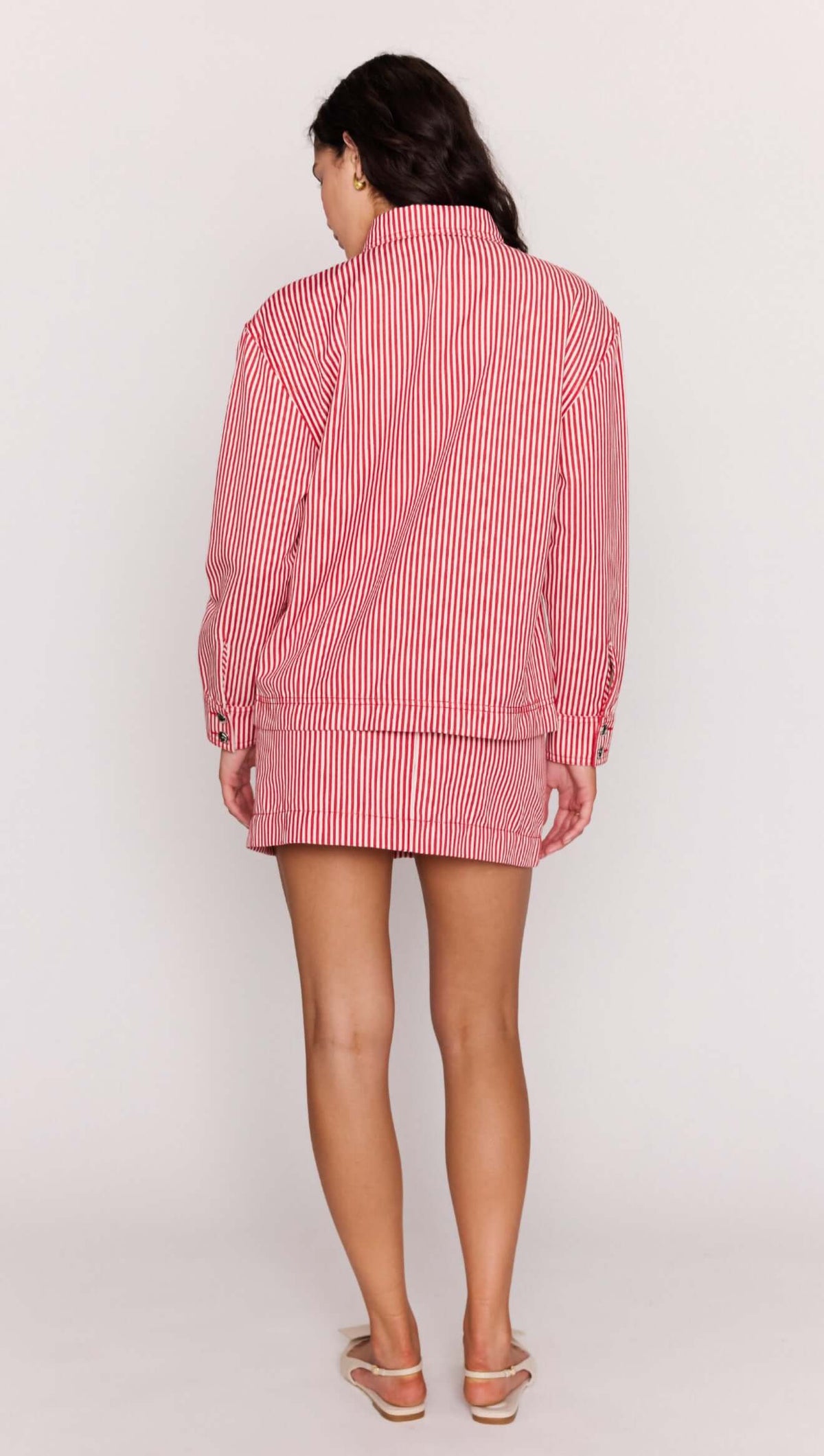 Red Pinstriped Denim Jacket worn as a stylish set with matching mini skirt, showcasing its relaxed fit and vertical stripes.