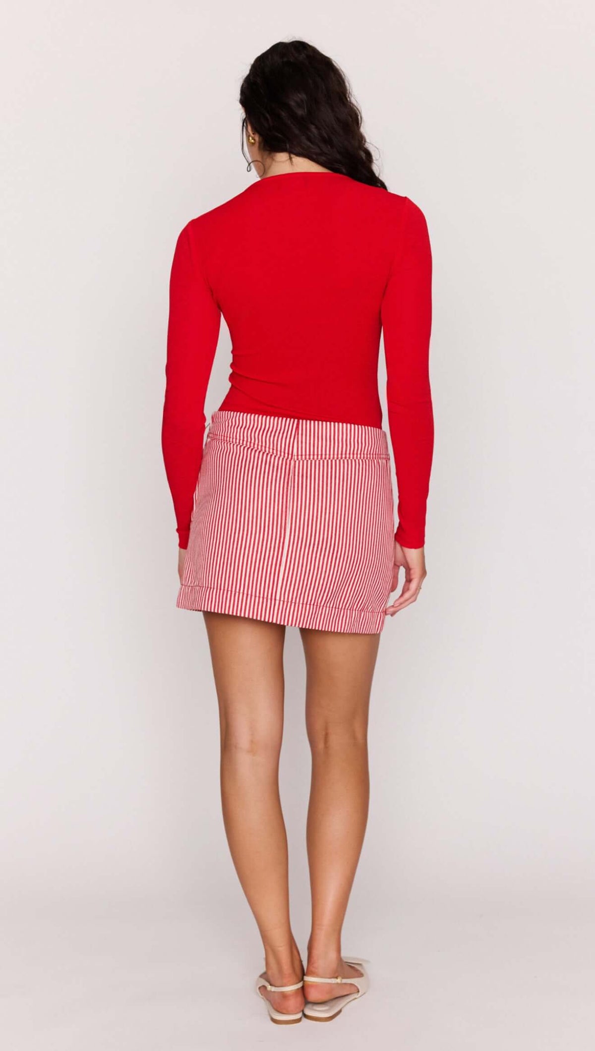 Model wearing the Red Twist Cut Out Top, showcasing the fitted silhouette and twist front design from the back.