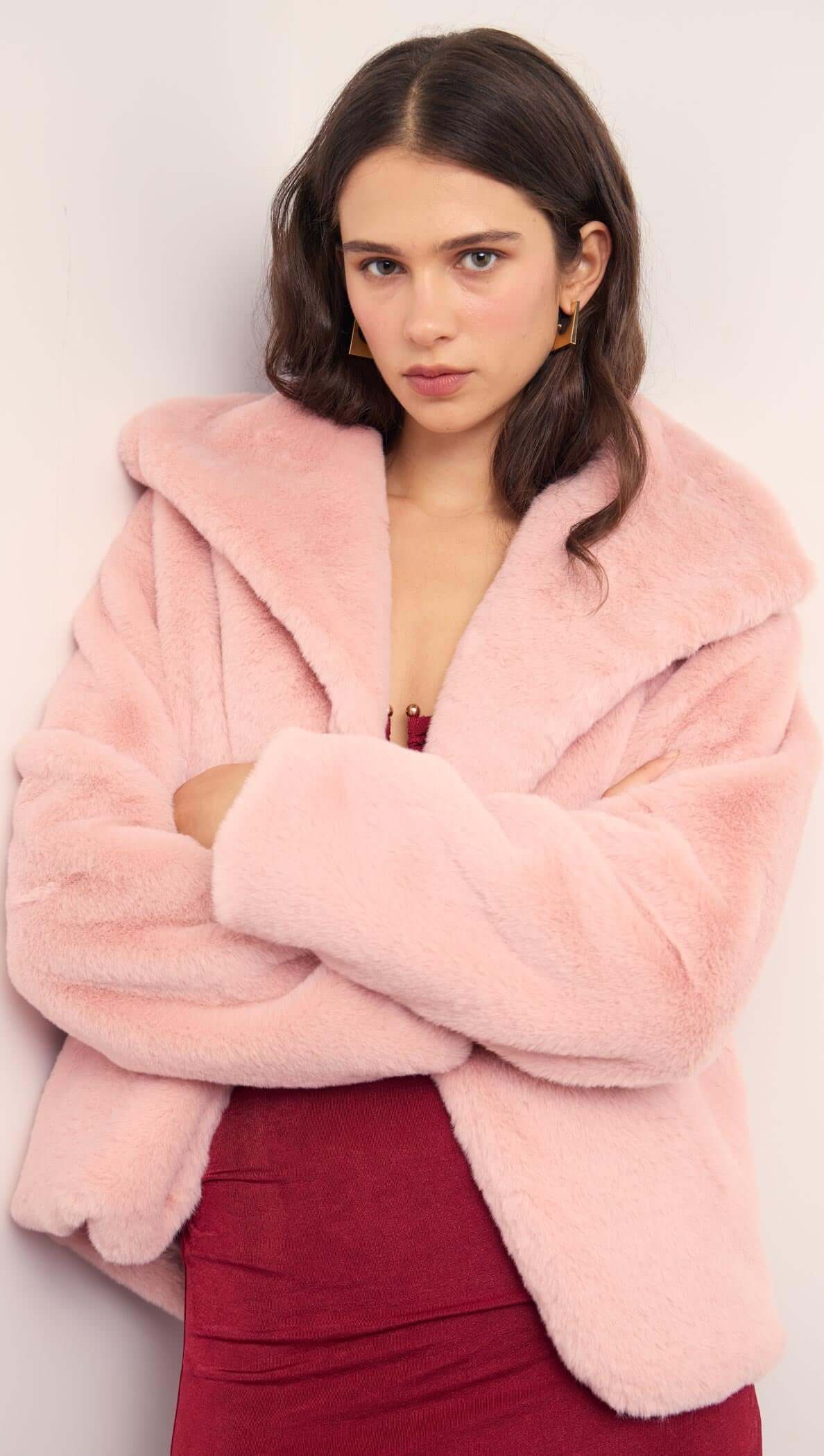 Woman wearing a Dusty Pink Faux Fur Coat with oversized collar for a stylish winter look.