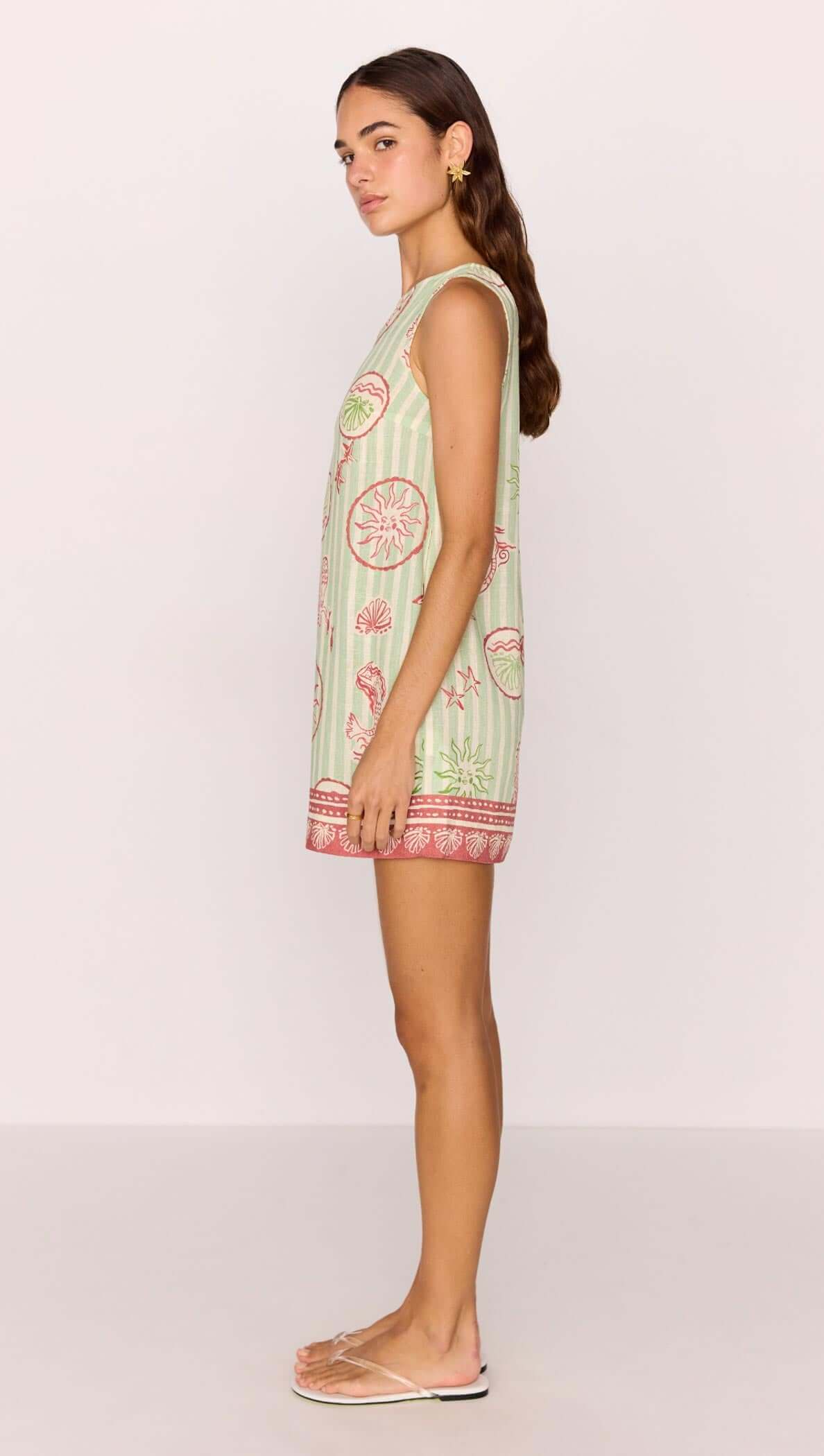 Linen Blend Green Stripe Printed Shift Mini Dress shown on model in profile view, featuring coastal motif print and relaxed silhouette.
