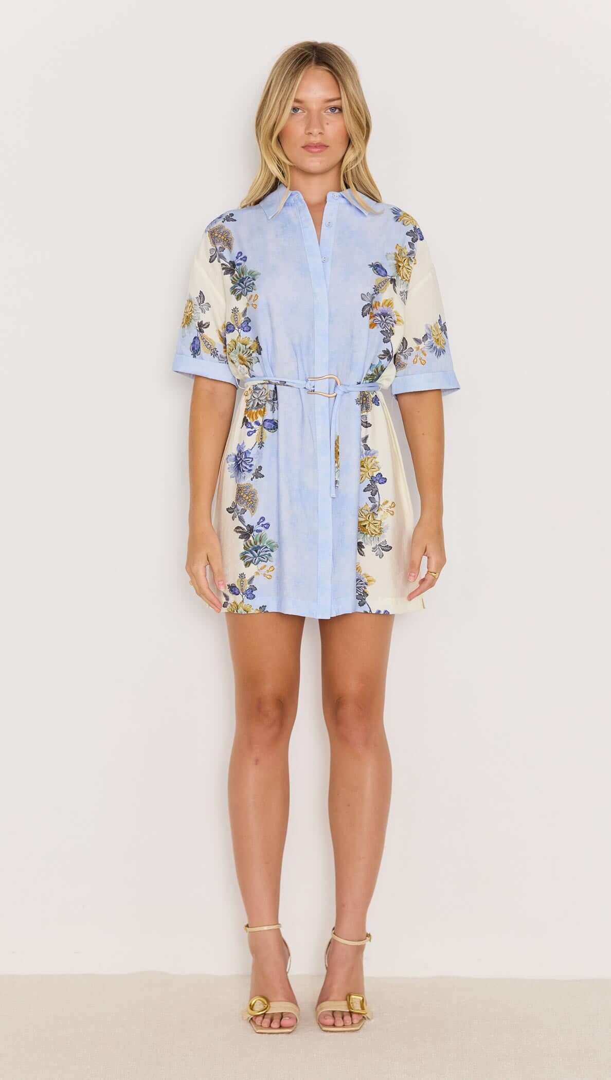 Lucia blue floral mini shirtdress with tie waist, featuring a relaxed fit and rolled short sleeves.