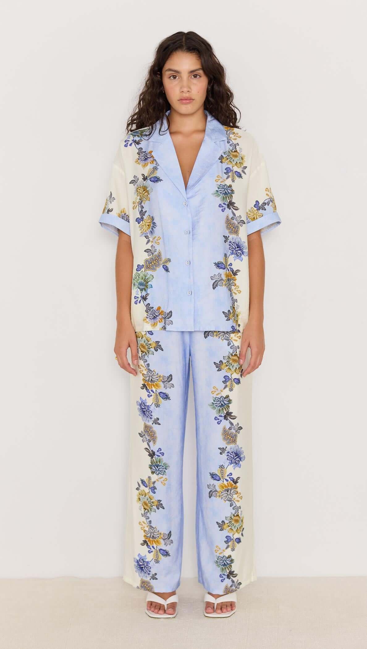LUCIA Resort Shirt in blue floral print, featuring a relaxed fit and paired with matching pants for a stylish warm-weather look.