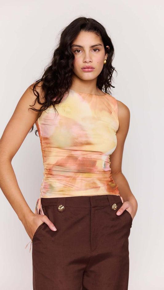Model wearing Sunset Tonal Drawstring Mesh Top with adjustable side drawstrings and sun-washed print.