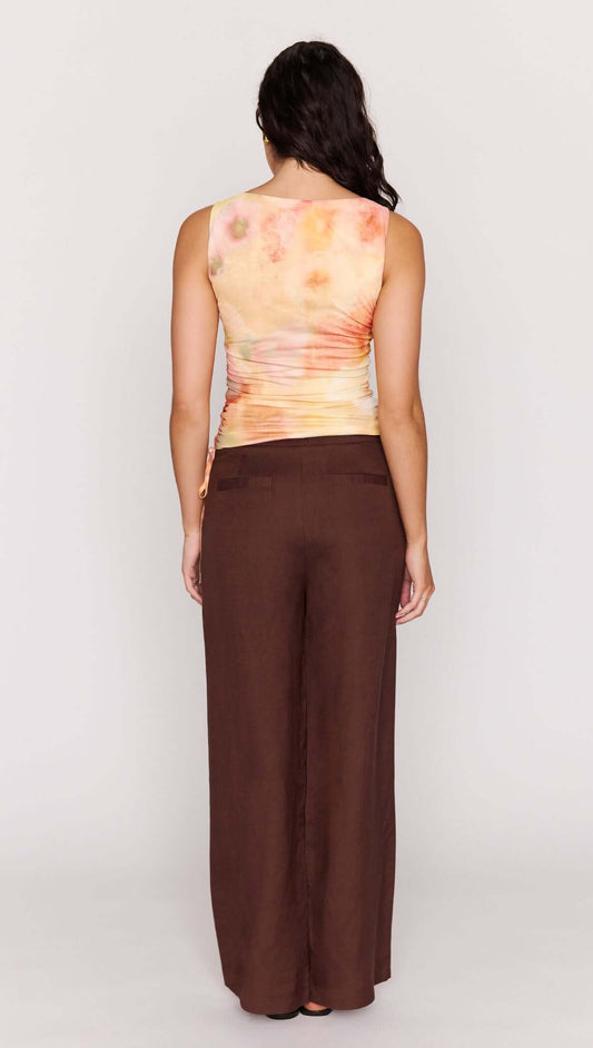 Back view of a model wearing the Sunset Tonal Drawstring Mesh Top with adjustable side drawstrings.