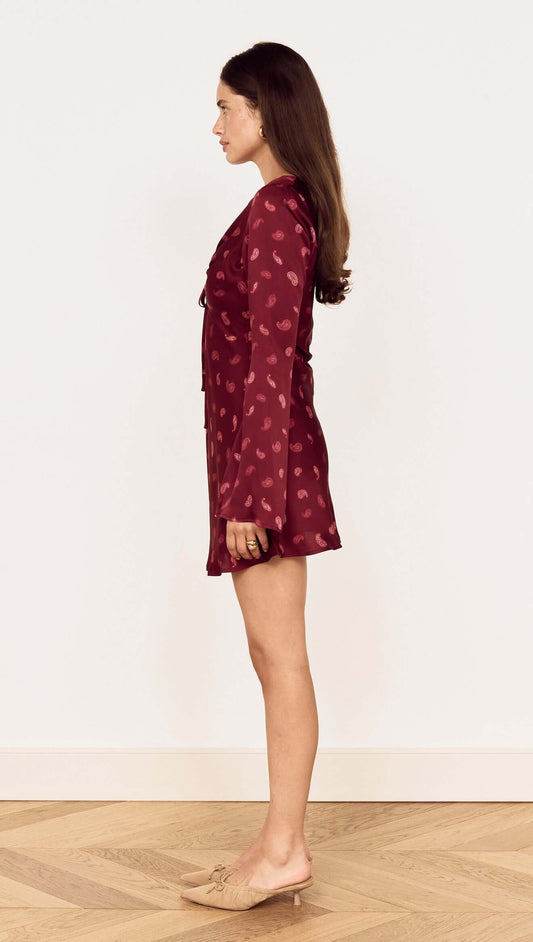 Wine Satin Paisley Knot Front Bias Mini Dress showcased from the side, featuring flared sleeves and a rich paisley print.