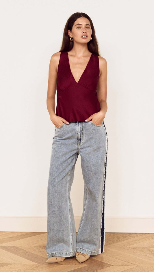 Model wearing Wine Satin V-Neck Cami Top with relaxed denim for a stylish look.