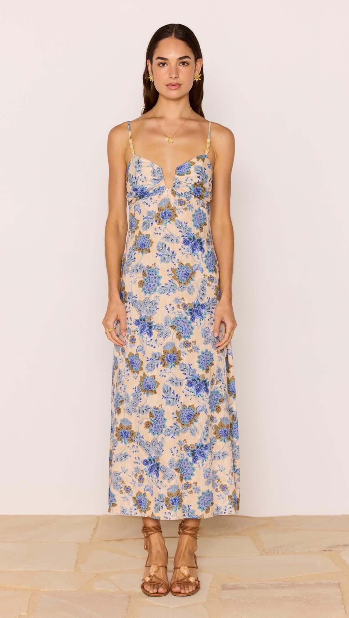 Linen Blend Blue Floral Bias Midi Dress displayed on a model with adjustable straps and blue floral print.