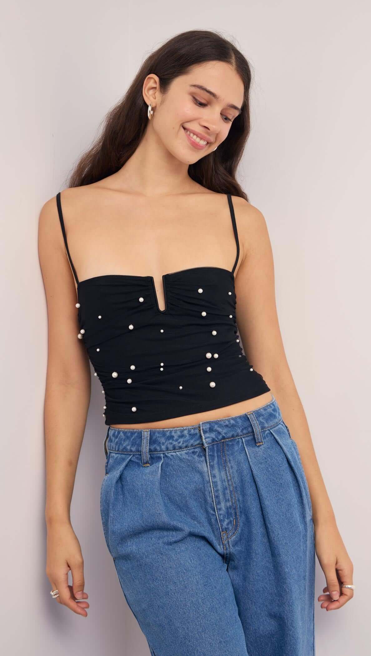 Pearl Embellished Black Mesh Crop Top worn by model, featuring pearl details and a flattering sweetheart neckline.