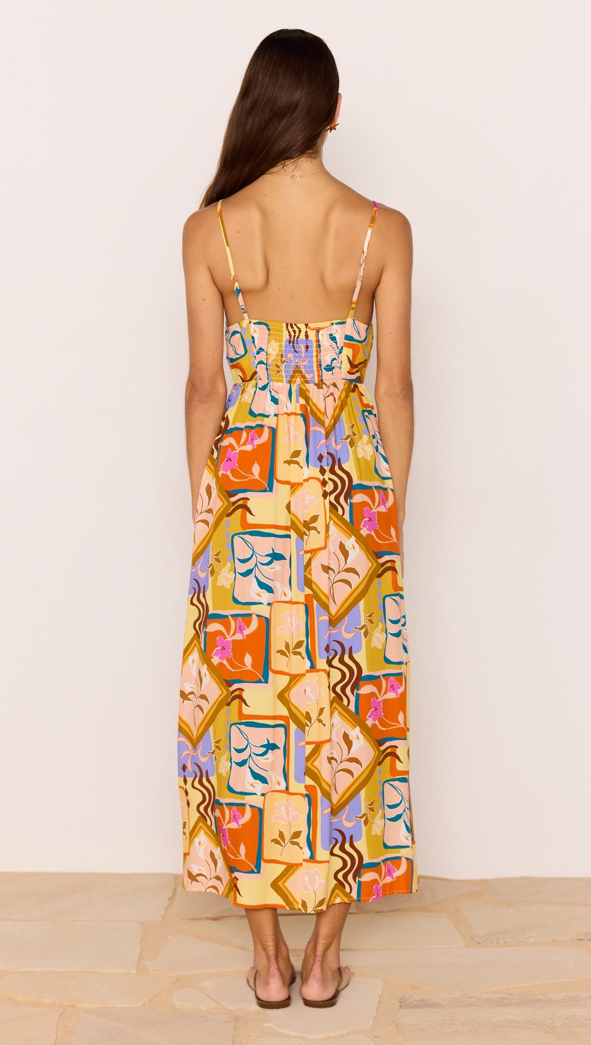 Back view of the Bold Scarf Print Midi Dress With Cut Out, showcasing vibrant abstract print and adjustable straps.
