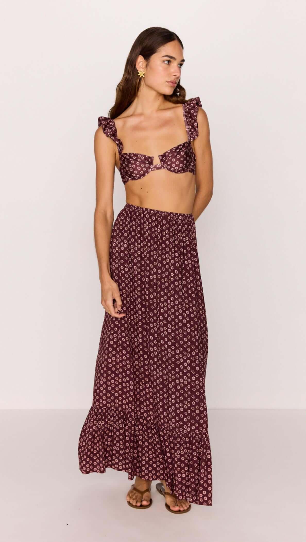 Model wearing a ruffle hem maxi skirt in burgundy floral print paired with matching crop top, perfect for summer outfits.