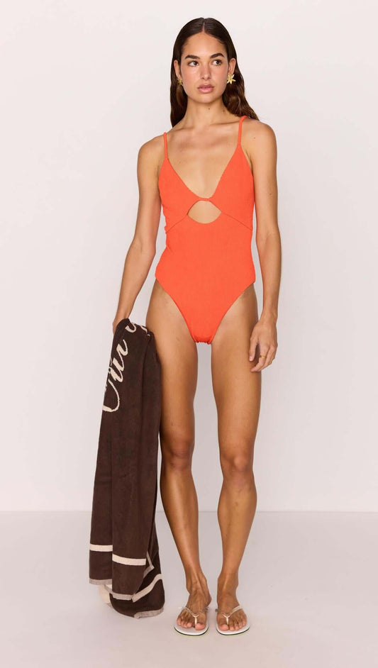 Scarlett Red Cut-Out Swimsuit worn by a model, featuring a V-neckline and cut-out detail, perfect for summer.