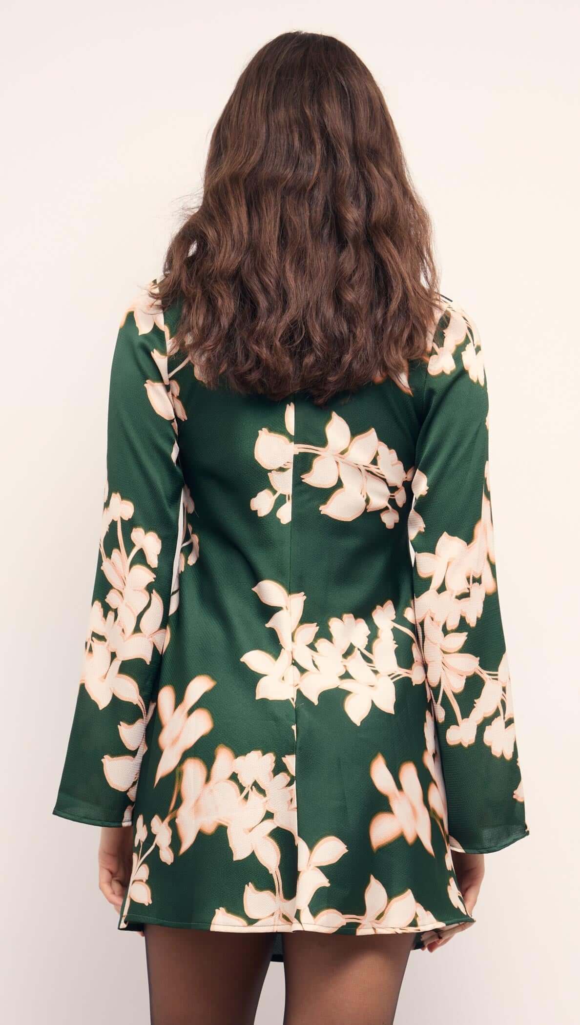 Back view of the Green & Cream Floral Satin Mini Dress featuring long sleeves and floral design.