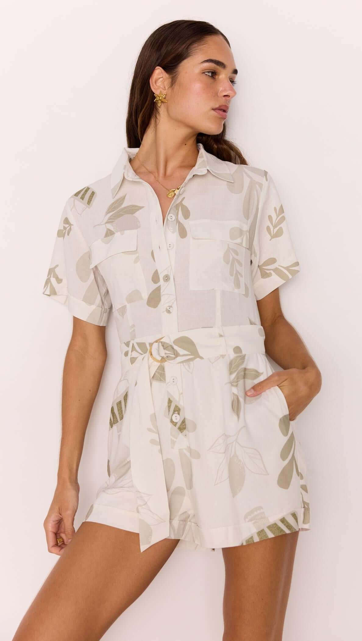 Model showcasing the White & Sage Leaf Print Playsuit with a collared neckline and matching fabric belt.