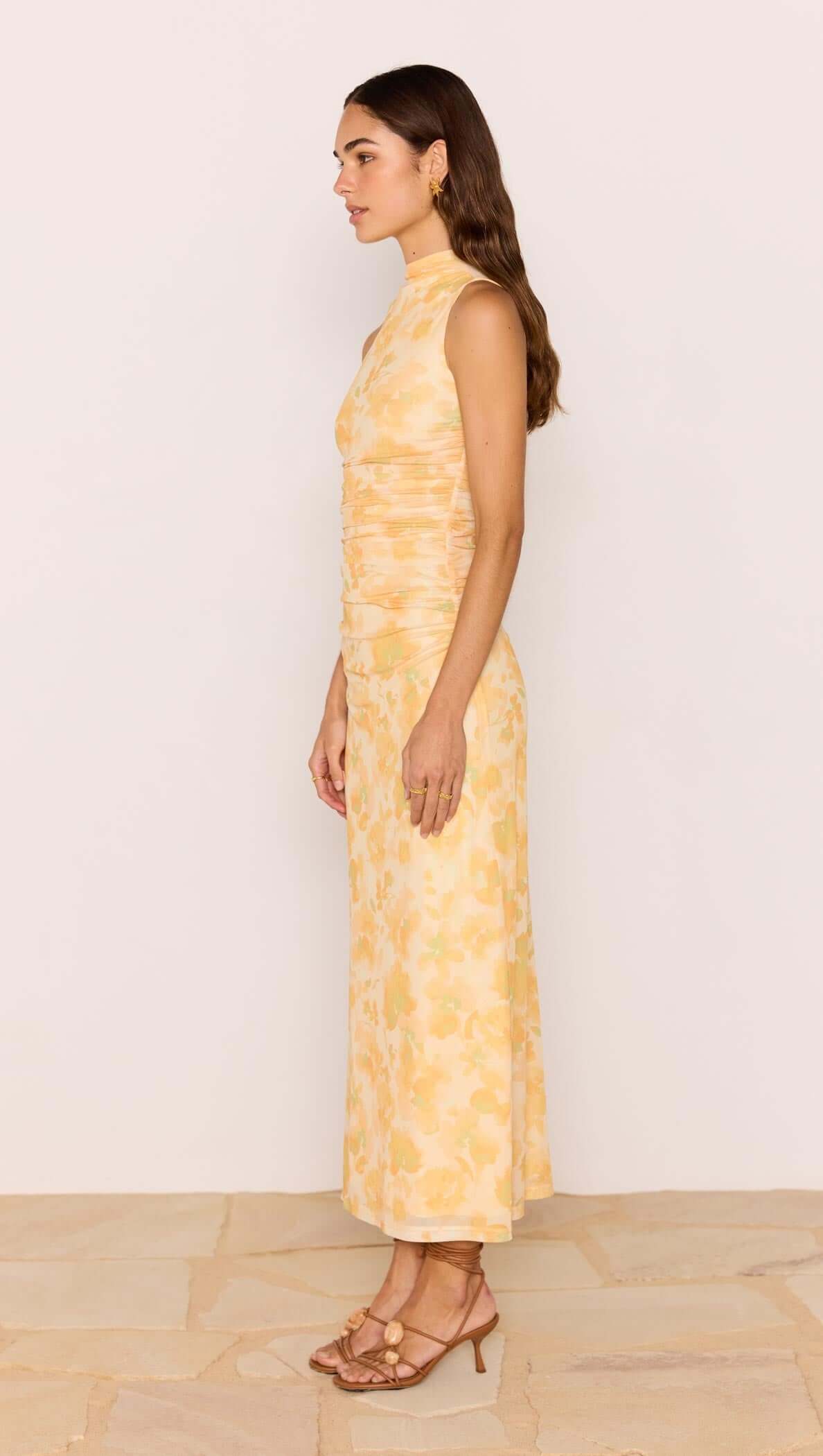 Yellow Floral Mesh Midi Dress showcased on a model, featuring soft ruching and a high neckline in a vibrant yellow floral print.