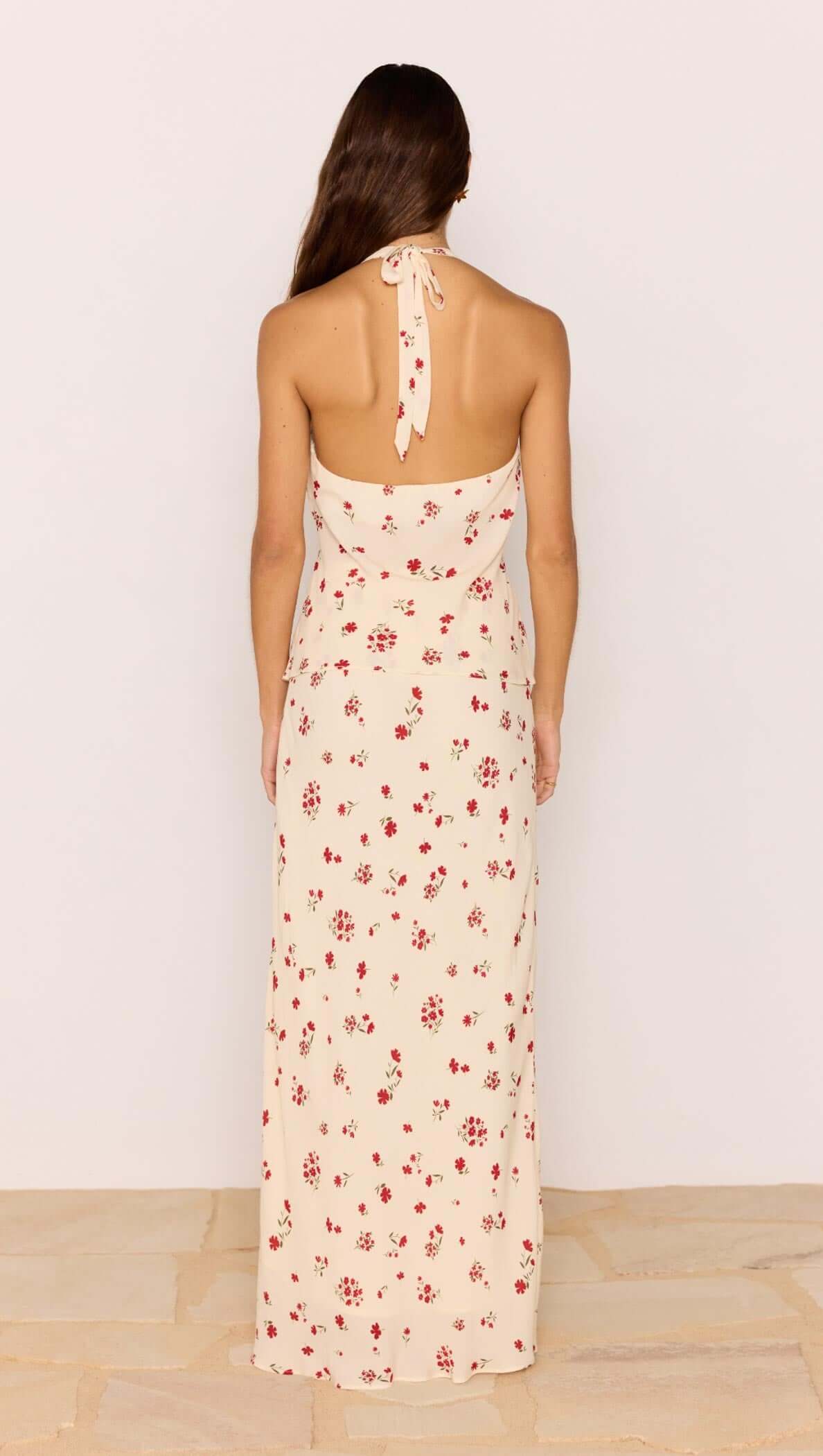 Model showcasing the back of the Red & Cream Floral Ruffle Bias Maxi Skirt on a light background.