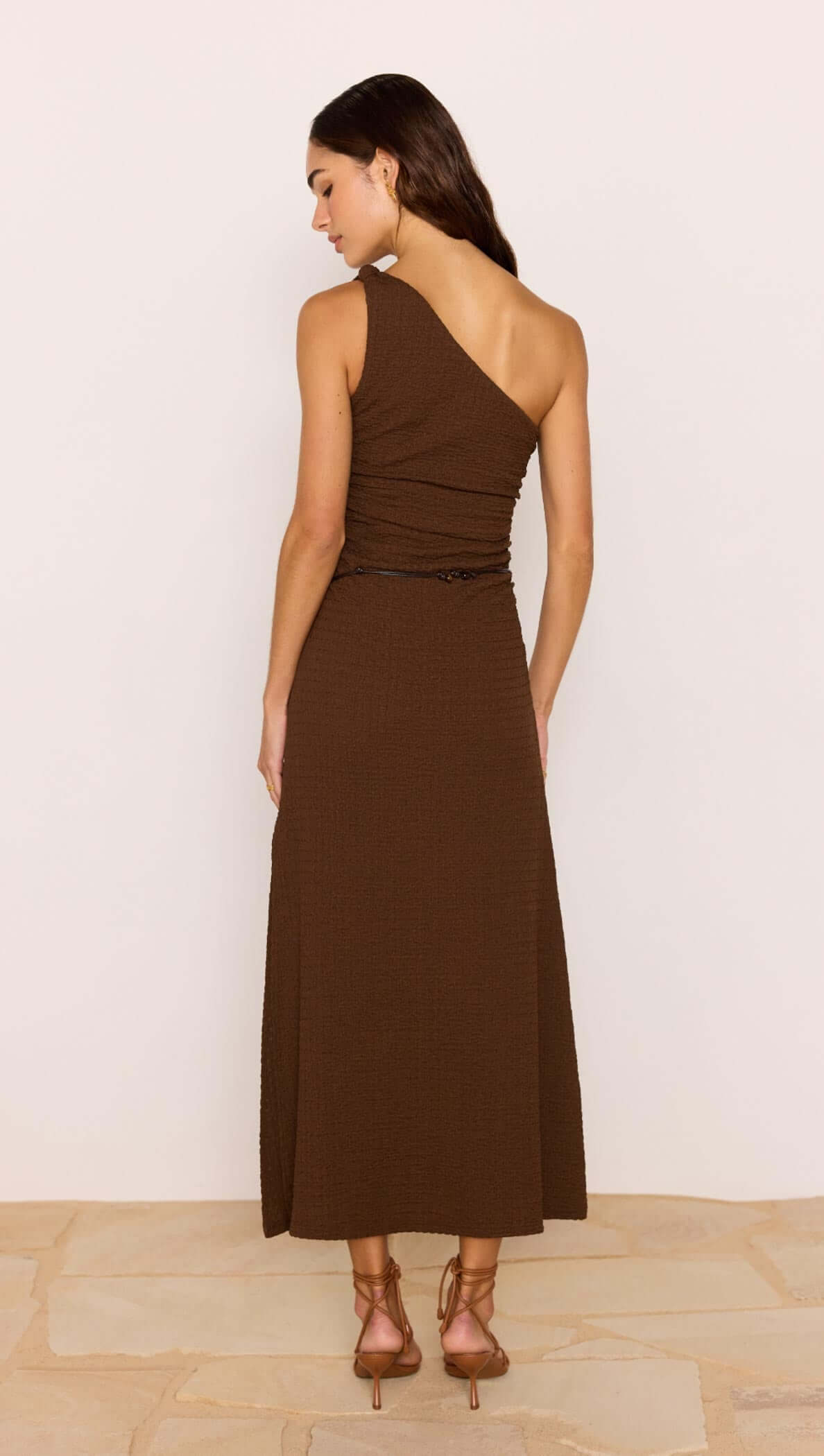 Back view of One-Shoulder Brown Midi Dress with Beaded Belt showcasing its elegant design and silhouette.