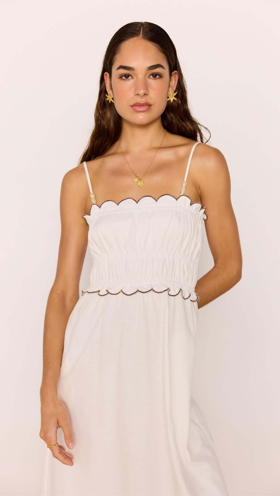 Scallop Edge Cotton White Midi Dress worn by a model, featuring a scalloped neckline and flowy silhouette.