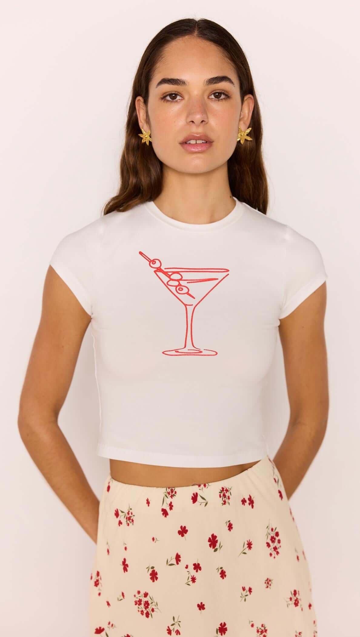 Martini Baby Tee featuring a playful red martini glass print, styled with a floral skirt.