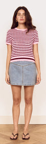 Model wearing a Pink Stripe Pointelle Knit Tee with denim skirt, showcasing a casual summer look.