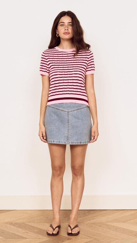 Model wearing a Pink Stripe Pointelle Knit Tee with denim skirt, showcasing a casual summer look.