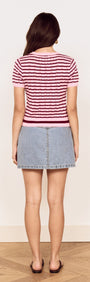Back view of a model wearing a Pink Stripe Pointelle Knit Tee paired with a denim skirt.