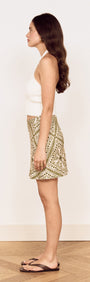 Scarf Print Bias Mini Skirt in Olive worn by a model, showcasing the side view and floral print design.