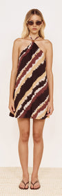 Model wearing Halter Mini Dress in Abstract Stripe featuring a bold diagonal stripe print and halter neckline.