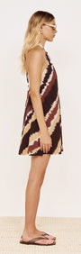 Halter Mini Dress in Abstract Stripe shown on a model from the side, featuring a relaxed A-line silhouette and bold print.